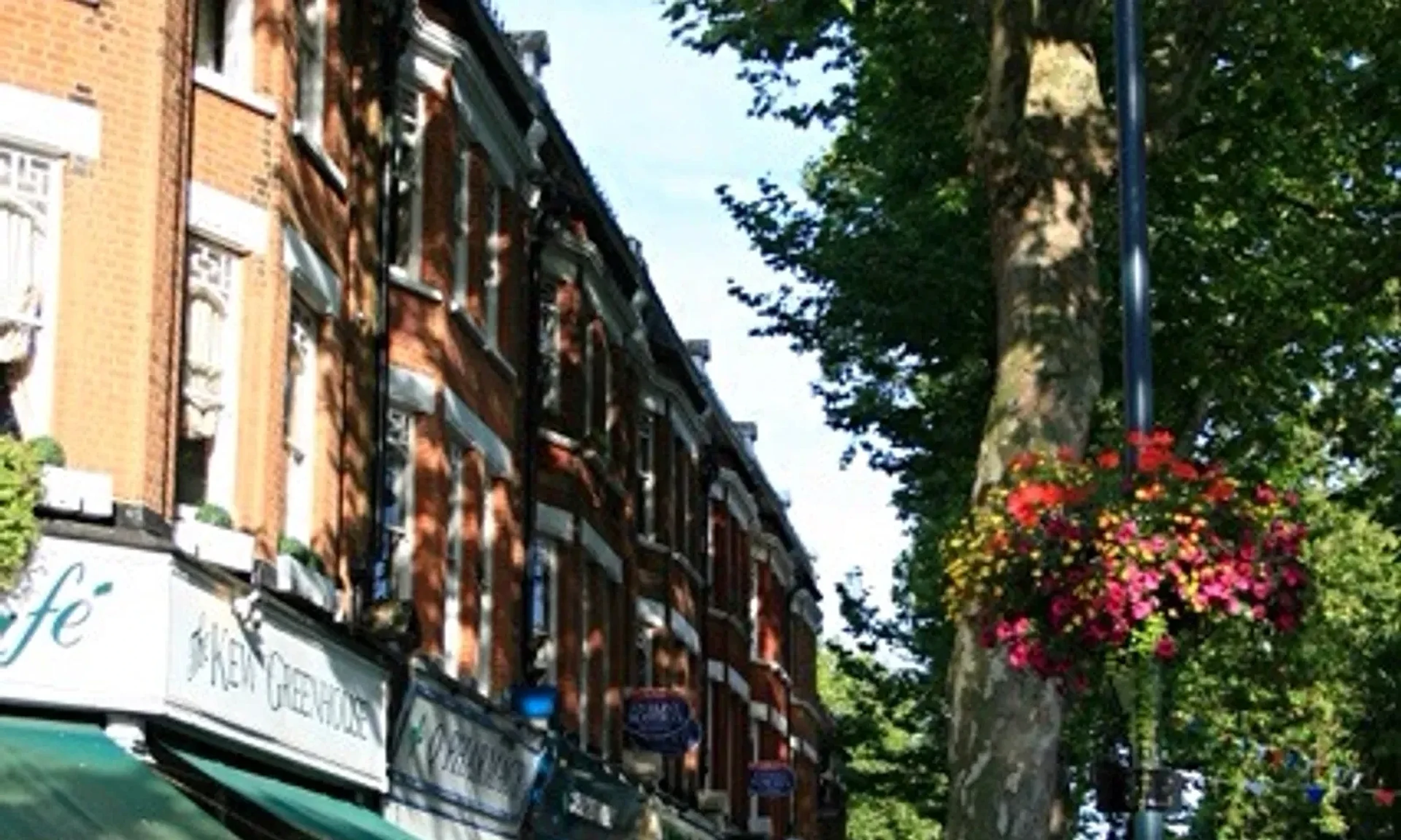 Shops and café tables near Kew Gardens station