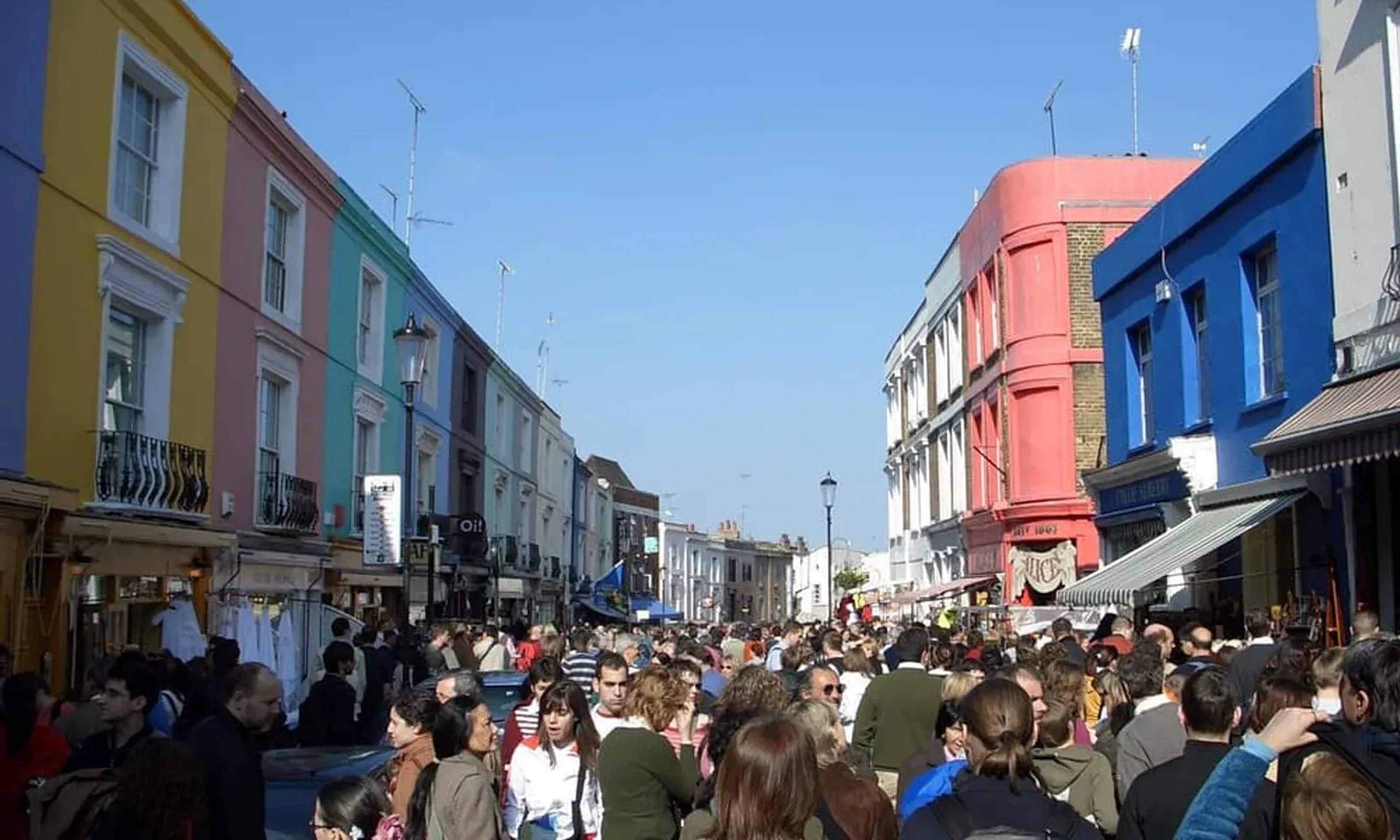 Colourful buildings and market stalls on Portobello Road in Notting Hill