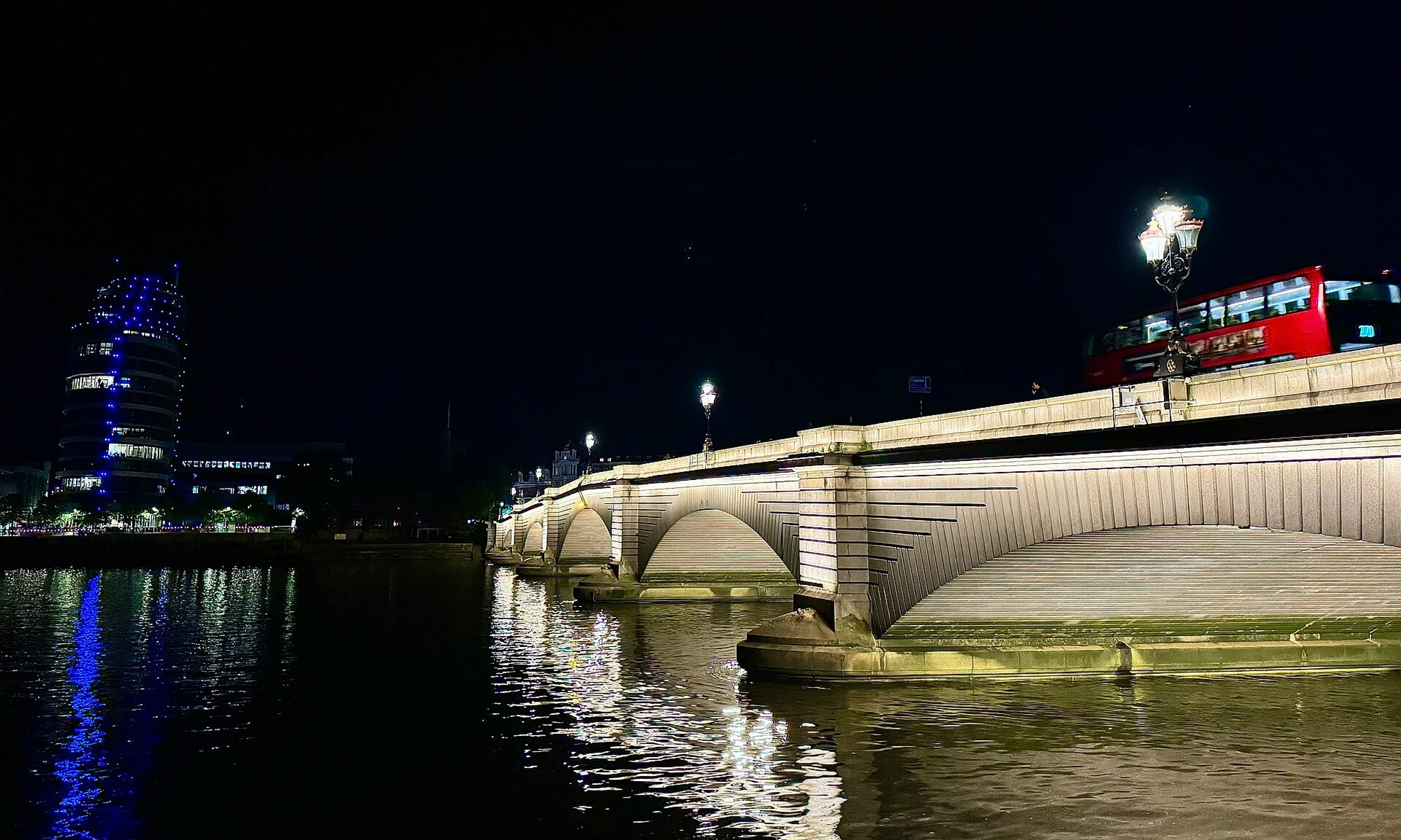 Putney Bridge illuminated beside the River Thames